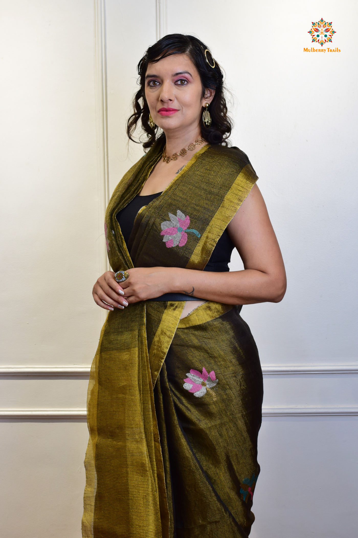 This image features an Elegant tissue saree featuring intricate handwoven Jamdani lotus motifs, with a lightweight, shimmery fabric that drapes beautifully, perfect for festive and special occasions. Party wear , diwali theme.