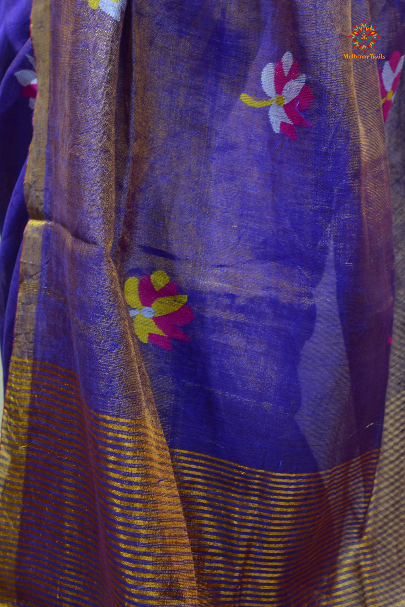 This image features an Elegant tissue saree featuring intricate handwoven Jamdani lotus motifs, with a lightweight, shimmery fabric that drapes beautifully, perfect for festive and special occasions. Party wear , diwali theme.