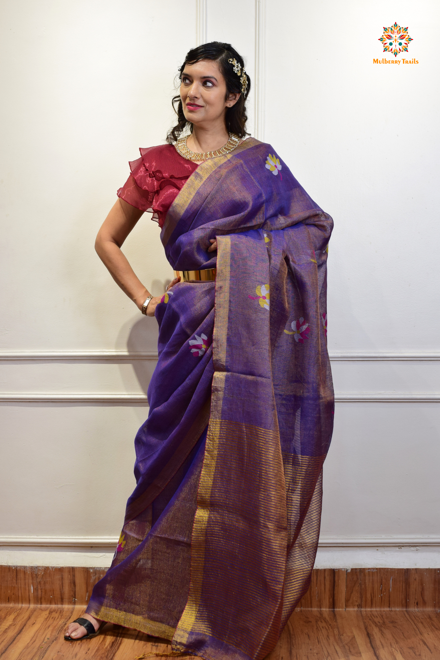 This image features an Elegant tissue saree featuring intricate handwoven Jamdani lotus motifs, with a lightweight, shimmery fabric that drapes beautifully, perfect for festive and special occasions. Party wear , diwali theme.