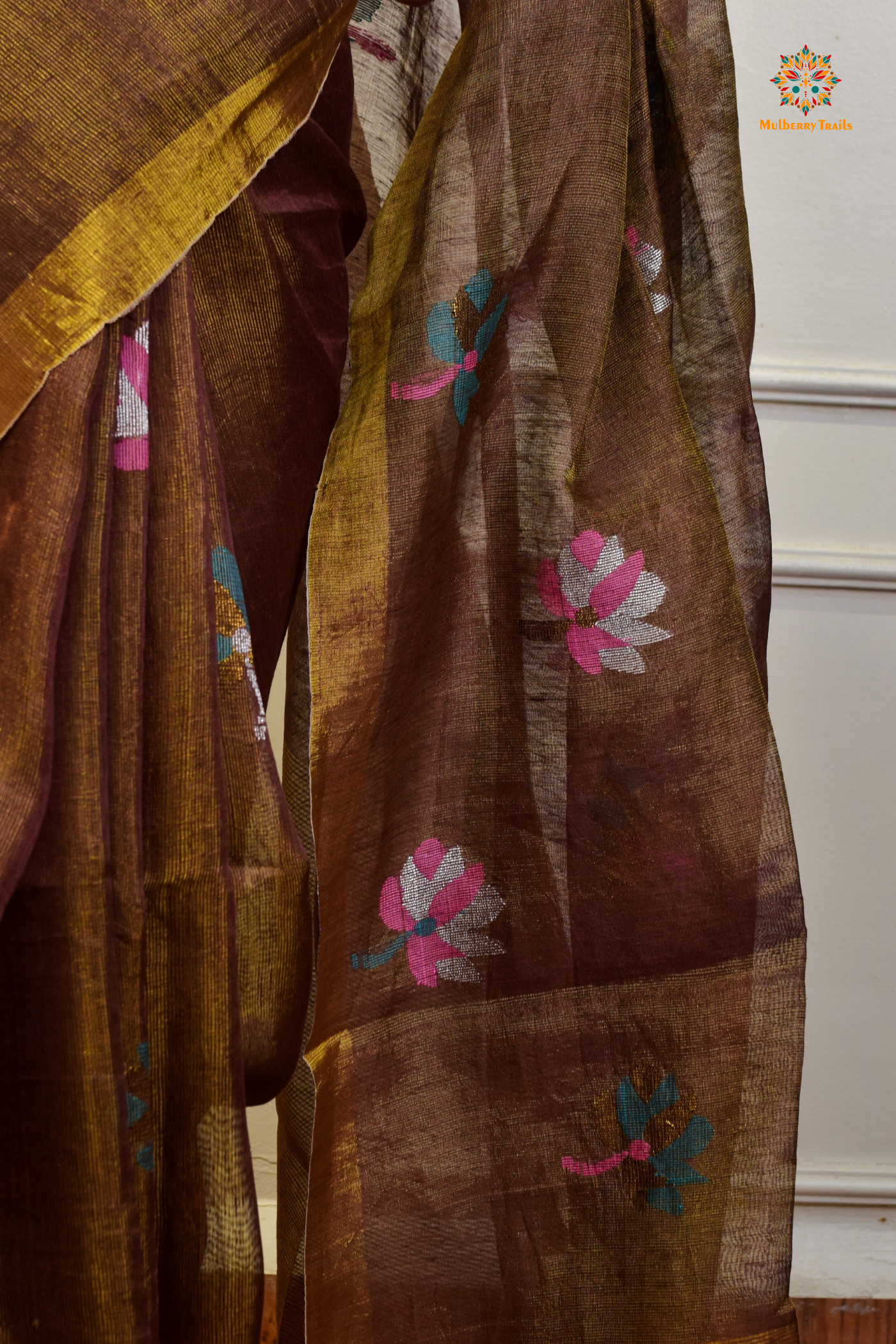 This image features an Elegant tissue saree featuring intricate handwoven Jamdani lotus motifs, with a lightweight, shimmery fabric that drapes beautifully, perfect for festive and special occasions. Party wear , diwali theme.