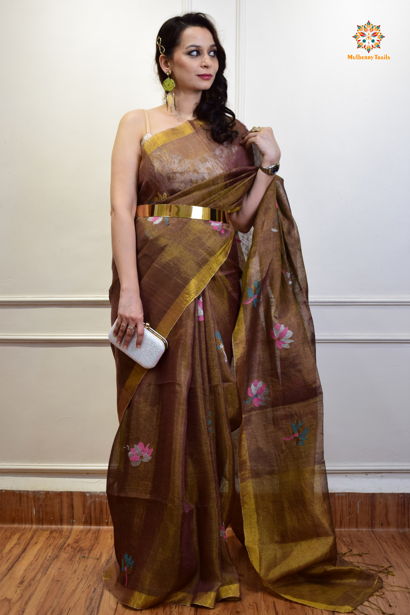 This image features an Elegant tissue saree featuring intricate handwoven Jamdani lotus motifs, with a lightweight, shimmery fabric that drapes beautifully, perfect for festive and special occasions. Party wear , diwali theme.