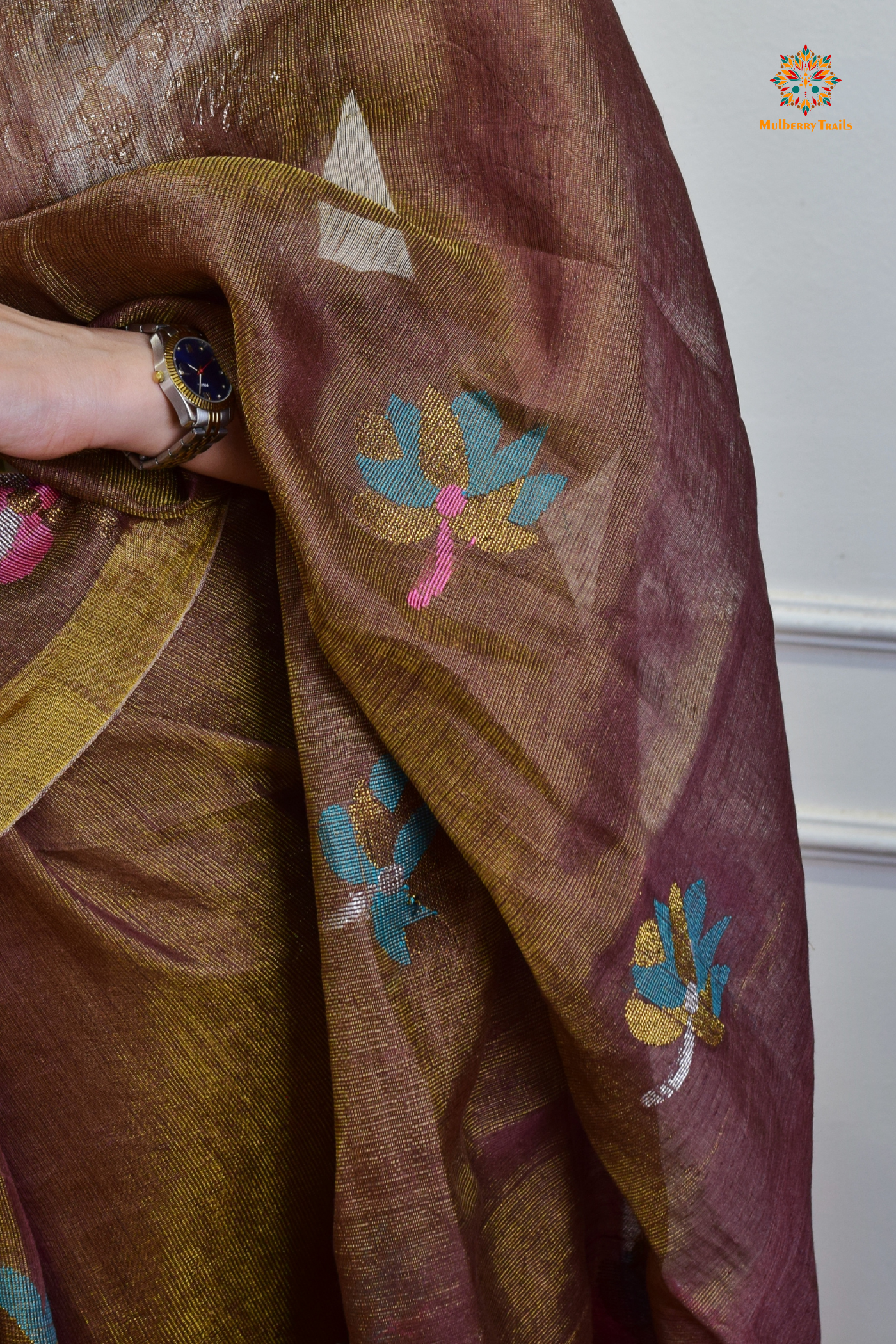 This image features an Elegant tissue saree featuring intricate handwoven Jamdani lotus motifs, with a lightweight, shimmery fabric that drapes beautifully, perfect for festive and special occasions. Party wear , diwali theme.