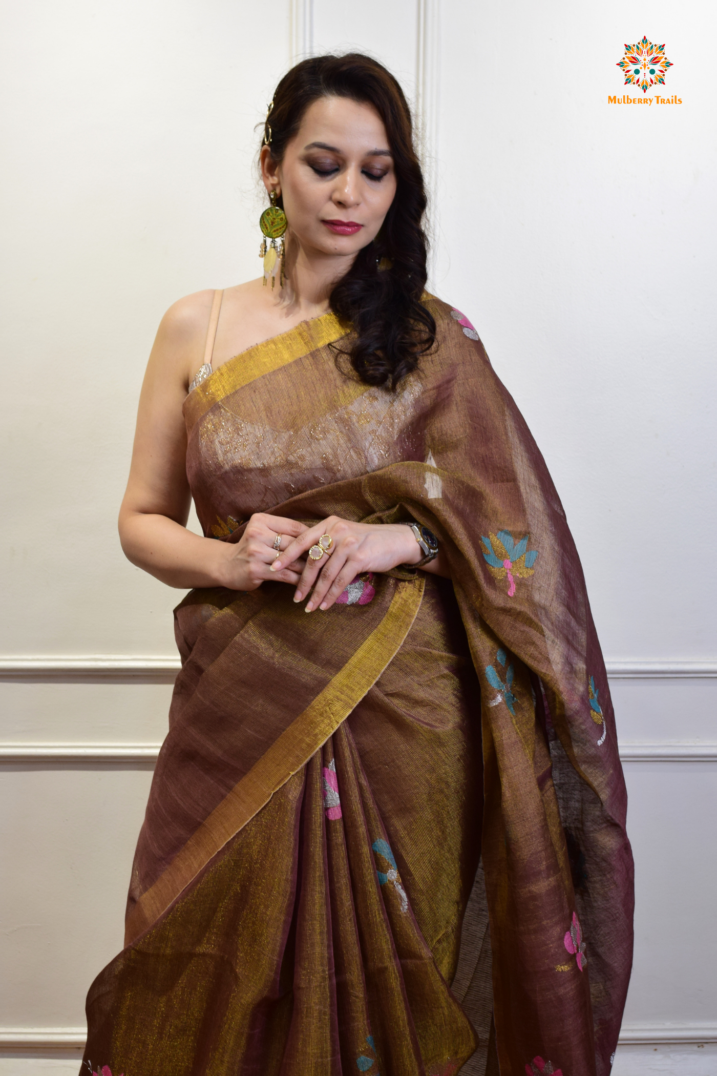 This image features an Elegant tissue saree featuring intricate handwoven Jamdani lotus motifs, with a lightweight, shimmery fabric that drapes beautifully, perfect for festive and special occasions. Party wear , diwali theme.