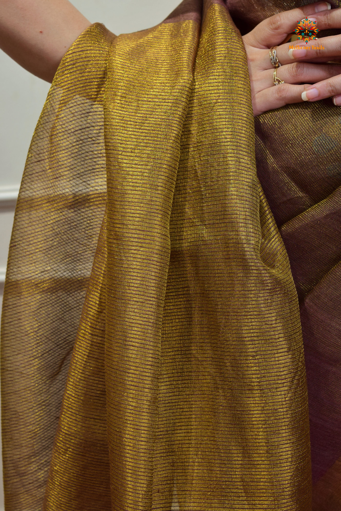 This image features an Elegant tissue saree featuring intricate handwoven Jamdani lotus motifs, with a lightweight, shimmery fabric that drapes beautifully, perfect for festive and special occasions. Party wear , diwali theme.