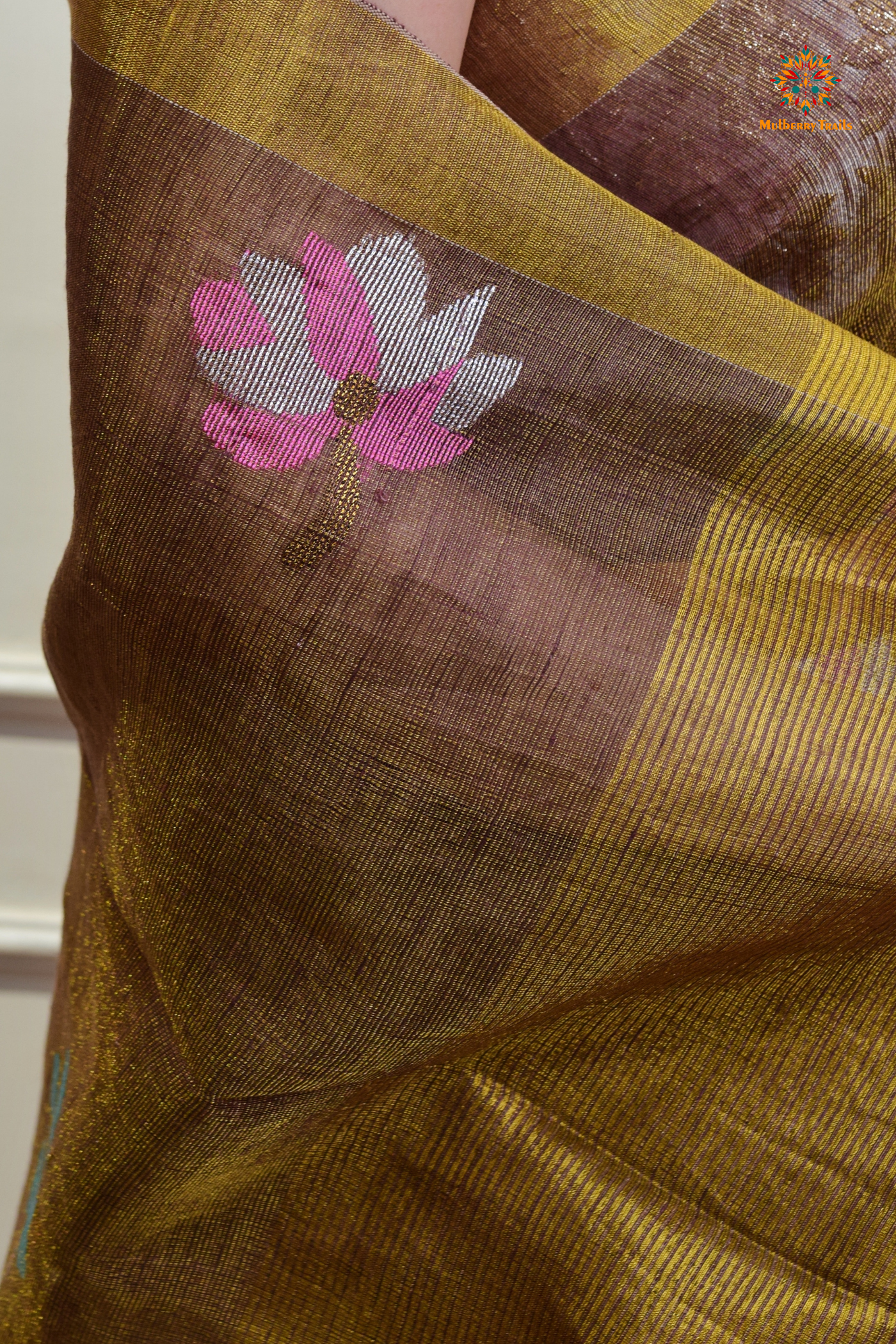 This image features an Elegant tissue saree featuring intricate handwoven Jamdani lotus motifs, with a lightweight, shimmery fabric that drapes beautifully, perfect for festive and special occasions. Party wear , diwali theme.