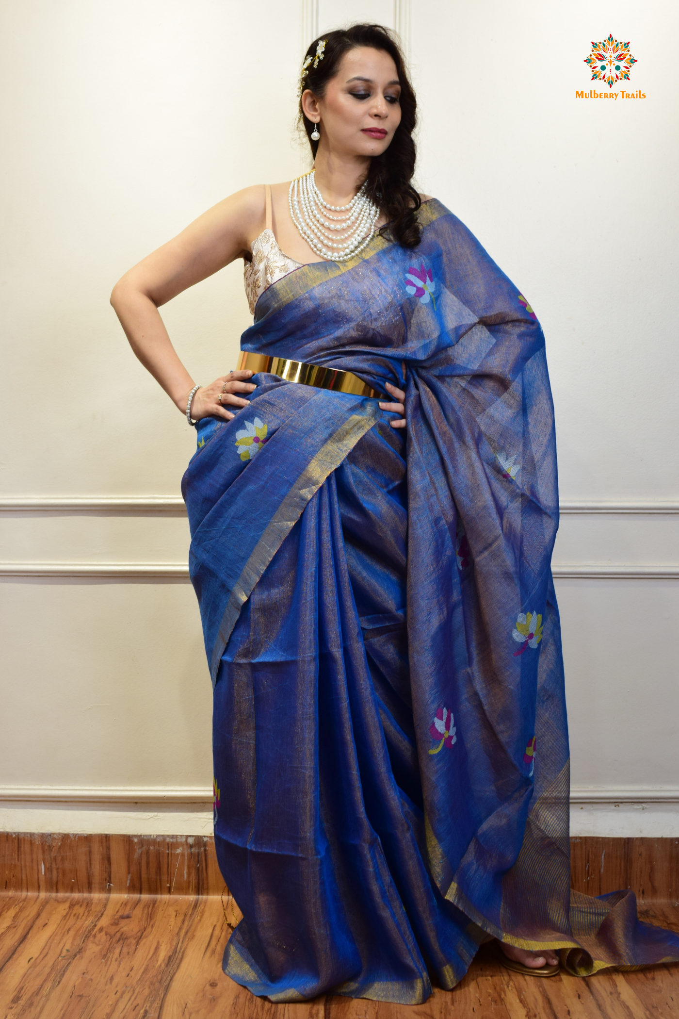 This image features an Elegant tissue saree featuring intricate handwoven Jamdani lotus motifs, with a lightweight, shimmery fabric that drapes beautifully, perfect for festive and special occasions. Party wear , diwali theme.