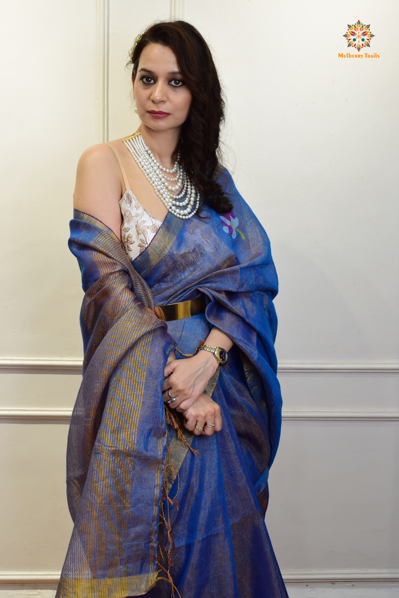 This image features an Elegant tissue saree featuring intricate handwoven Jamdani lotus motifs, with a lightweight, shimmery fabric that drapes beautifully, perfect for festive and special occasions. Party wear , diwali theme.