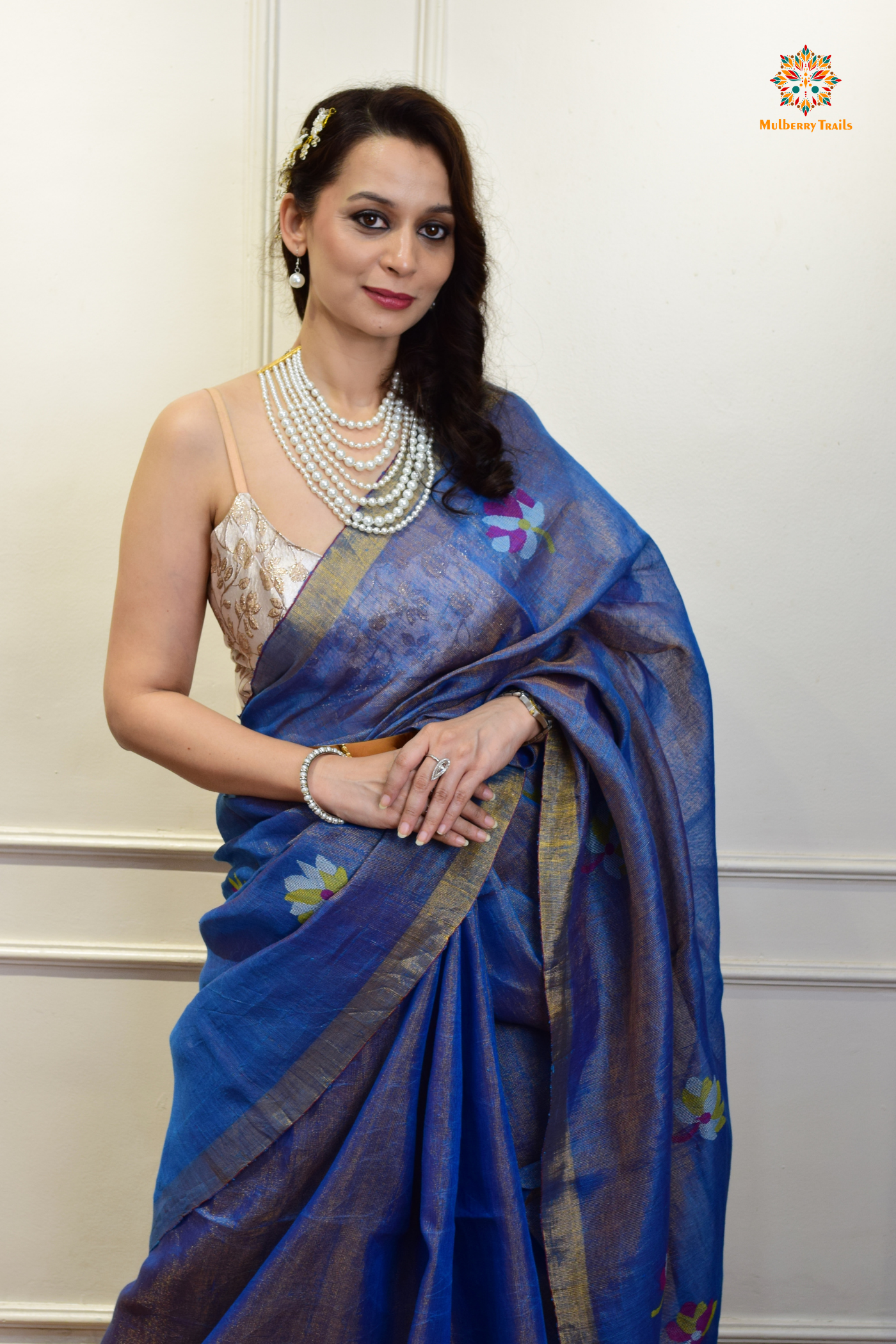 This image features an Elegant tissue saree featuring intricate handwoven Jamdani lotus motifs, with a lightweight, shimmery fabric that drapes beautifully, perfect for festive and special occasions. Party wear , diwali theme.