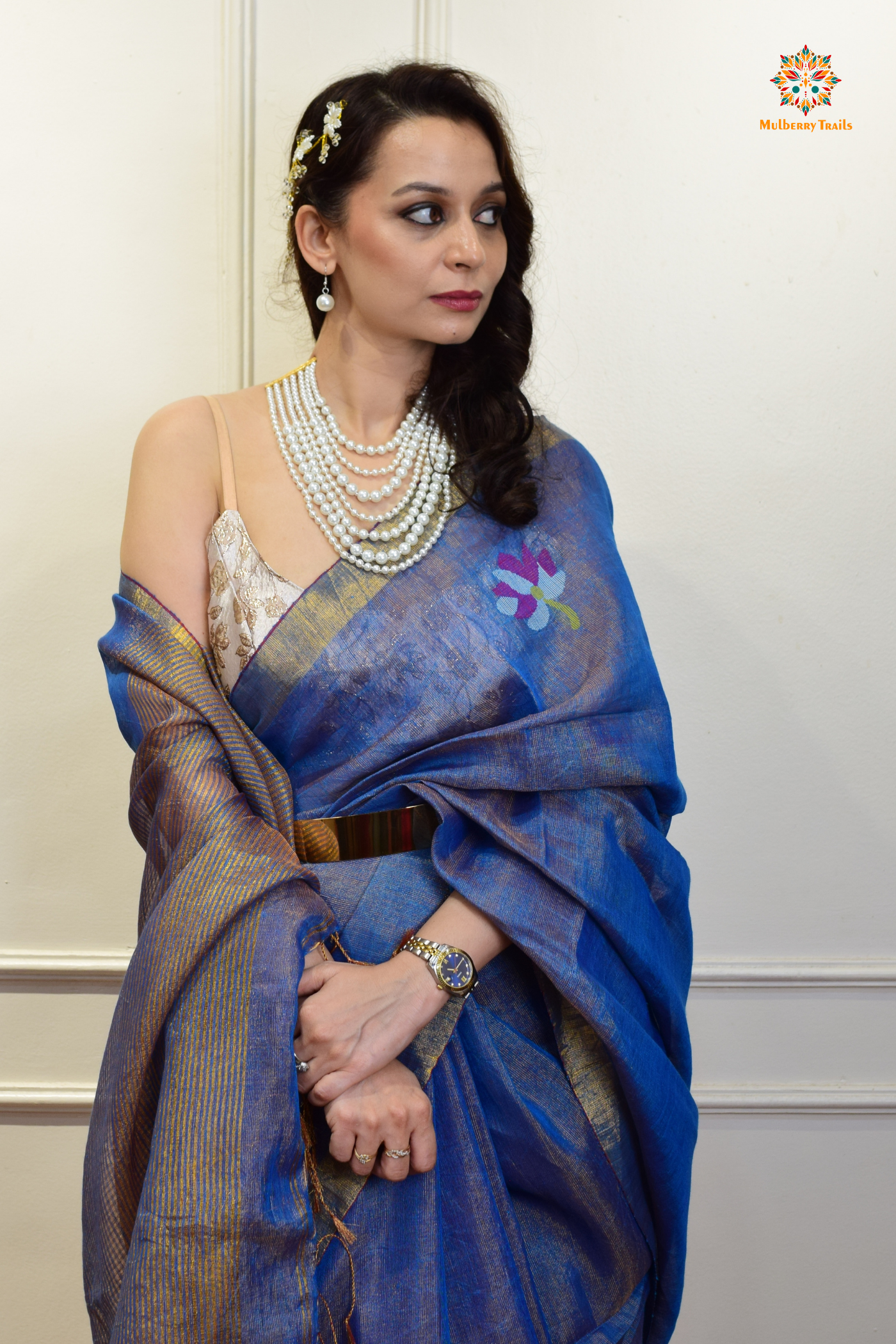 This image features an Elegant tissue saree featuring intricate handwoven Jamdani lotus motifs, with a lightweight, shimmery fabric that drapes beautifully, perfect for festive and special occasions. Party wear , diwali theme.