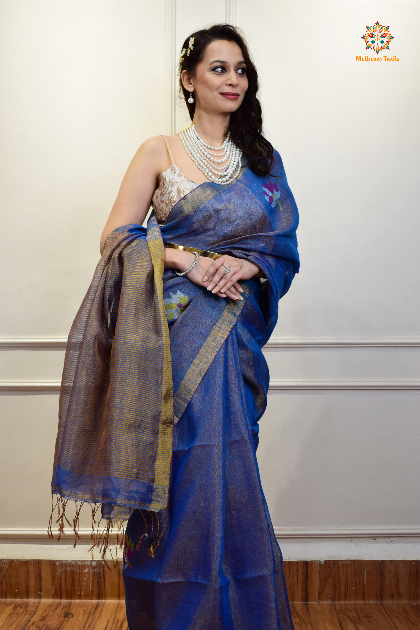 This image features an Elegant tissue saree featuring intricate handwoven Jamdani lotus motifs, with a lightweight, shimmery fabric that drapes beautifully, perfect for festive and special occasions. Party wear , diwali theme.