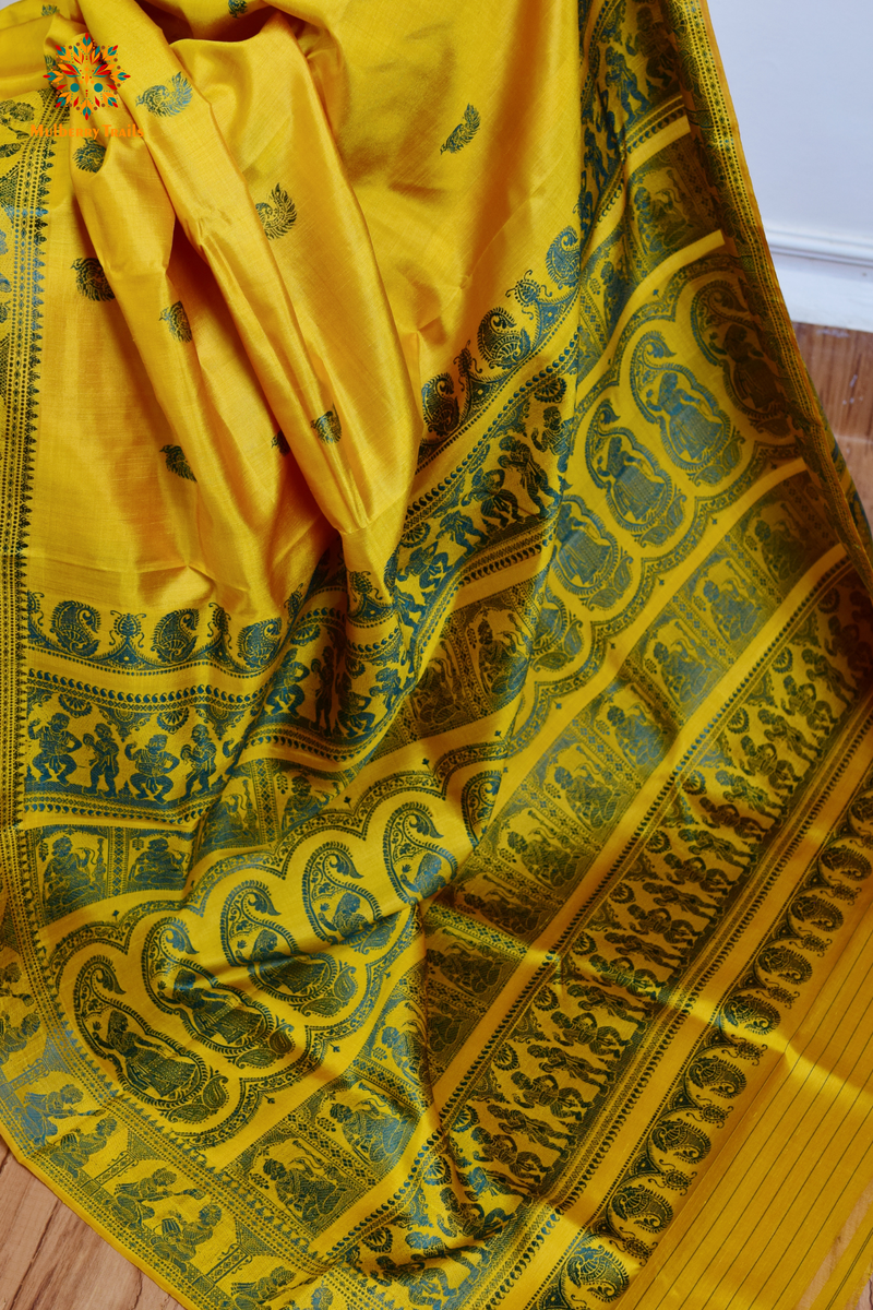 A woman wearing a Yellow Baluchari Pure SIlk saree. purple baluchari silk , bengal silk saree with deer motif on pallu and ramayan, mahabharat motifs on pallu. This is a soft pure silk saree suitable for weddings, parties, festivities. suitable for Durga Puja shopping enthusiasts and diwali festival. 