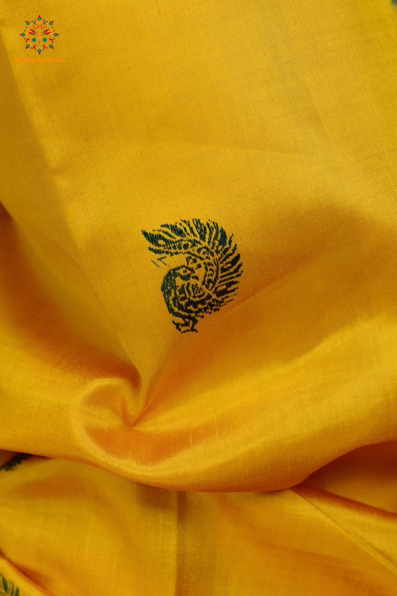 A woman wearing a Yellow Baluchari Pure SIlk saree. purple baluchari silk , bengal silk saree with deer motif on pallu and ramayan, mahabharat motifs on pallu. This is a soft pure silk saree suitable for weddings, parties, festivities. suitable for Durga Puja shopping enthusiasts and diwali festival. 