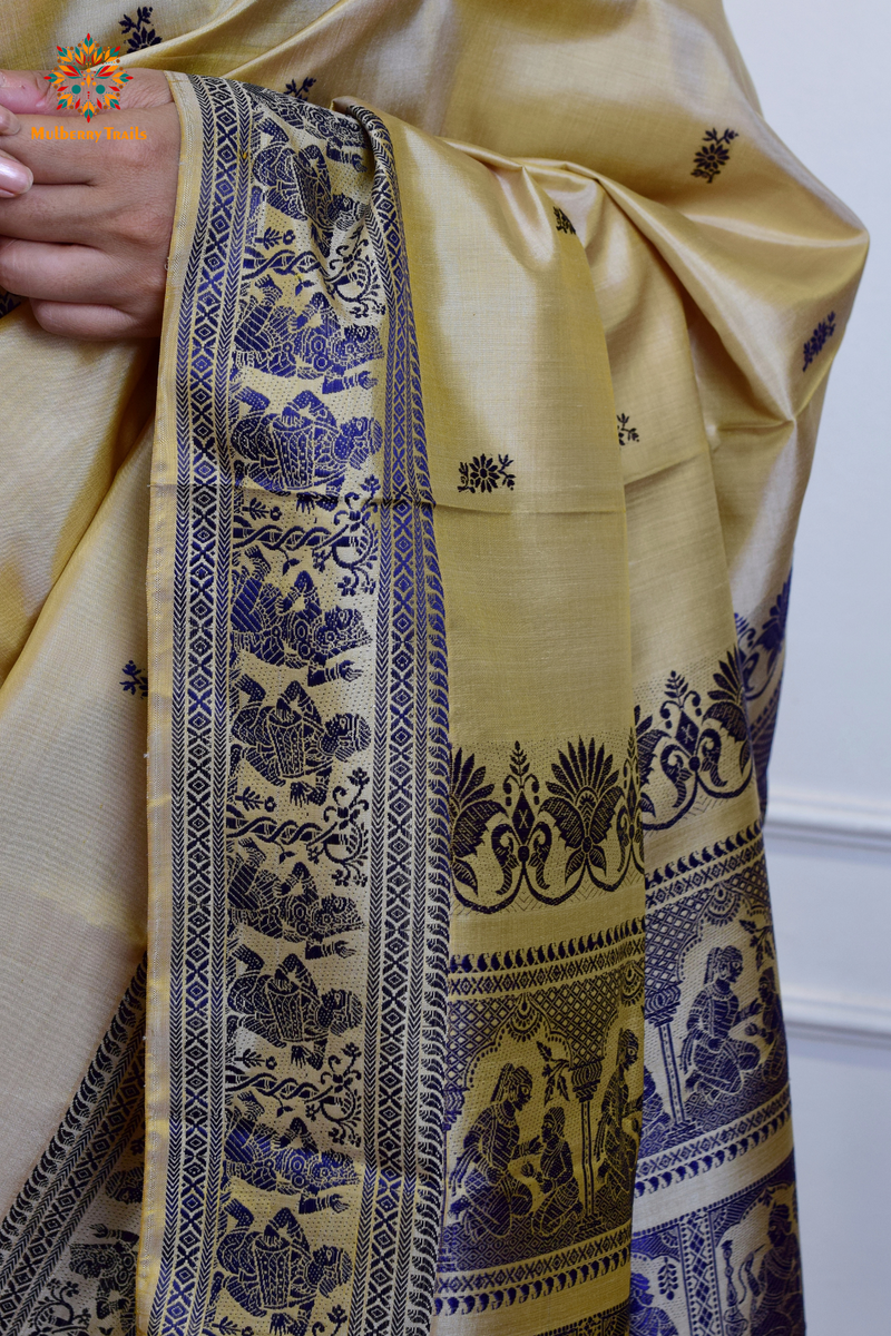 A woman wearing a Beige Baluchari Pure SIlk saree. purple baluchari silk , bengal silk saree with deer motif on pallu and ramayan, mahabharat motifs on pallu. This is a soft pure silk saree suitable for weddings, parties, festivities. suitable for Durga Puja shopping enthusiasts and diwali festival. 