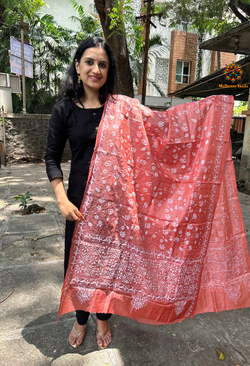 Elegant pure silk dupatta in peach Orange color, featuring intricate Kantha embroidery with vibrant floral and paisley motifs. The dupatta boasts a luxurious sheen and a rich texture, perfect for adding a touch of sophistication to any outfit. The hand-embroidered details highlight the traditional craftsmanship and artistry, making it a statement accessory for festive occasions or special events.