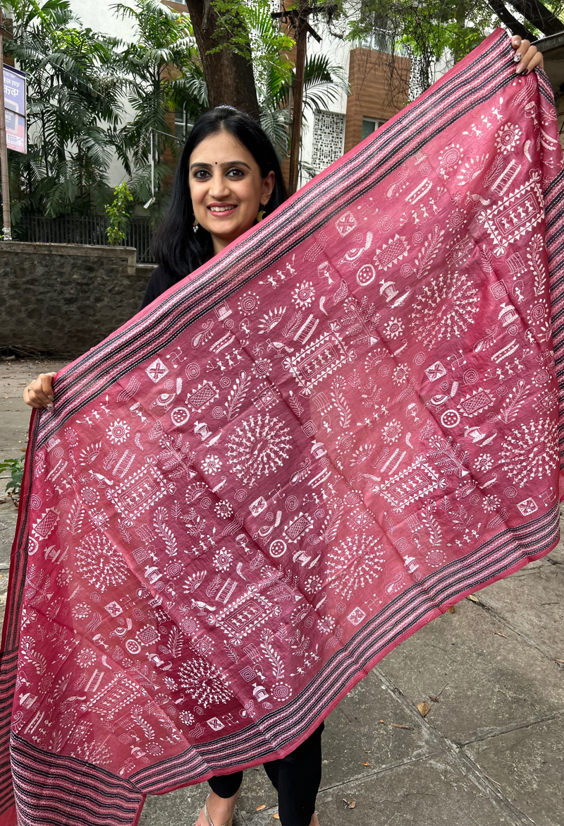 Elegant pure silk dupatta in Mauve color, featuring intricate Warli Kantha embroidery with vibrant floral and paisley motifs. The dupatta boasts a luxurious sheen and a rich texture, perfect for adding a touch of sophistication to any outfit. The hand-embroidered details highlight the traditional craftsmanship and artistry, making it a statement accessory for festive occasions or special events.