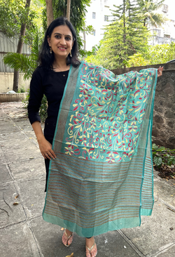 Elegant pure silk dupatta in Green color, featuring intricate Floral Kantha embroidery with vibrant floral and paisley motifs. The dupatta boasts a luxurious sheen and a rich texture, perfect for adding a touch of sophistication to any outfit. The hand-embroidered details highlight the traditional craftsmanship and artistry, making it a statement accessory for festive occasions or special events.