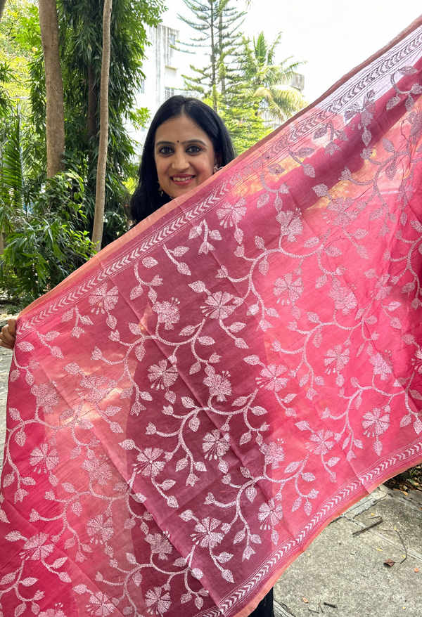 Elegant pure silk dupatta in peach Orange color, featuring intricate Kantha embroidery with vibrant floral and paisley motifs. The dupatta boasts a luxurious sheen and a rich texture, perfect for adding a touch of sophistication to any outfit. The hand-embroidered details highlight the traditional craftsmanship and artistry, making it a statement accessory for festive occasions or special events.