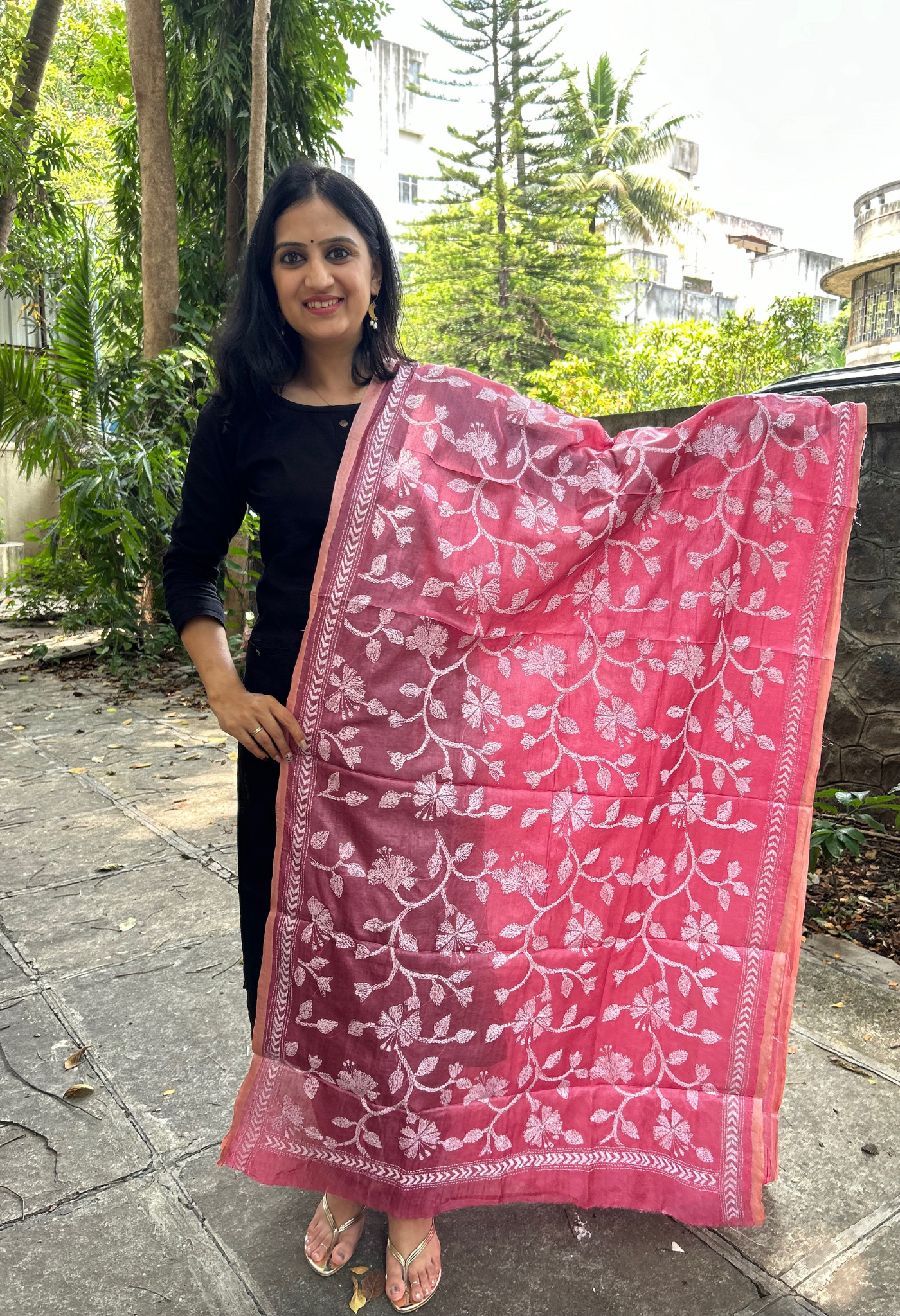 Elegant pure silk dupatta in peach Orange color, featuring intricate Kantha embroidery with vibrant floral and paisley motifs. The dupatta boasts a luxurious sheen and a rich texture, perfect for adding a touch of sophistication to any outfit. The hand-embroidered details highlight the traditional craftsmanship and artistry, making it a statement accessory for festive occasions or special events.