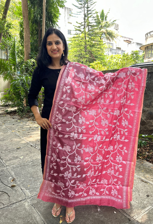 Elegant pure silk dupatta in peach Orange color, featuring intricate Kantha embroidery with vibrant floral and paisley motifs. The dupatta boasts a luxurious sheen and a rich texture, perfect for adding a touch of sophistication to any outfit. The hand-embroidered details highlight the traditional craftsmanship and artistry, making it a statement accessory for festive occasions or special events.