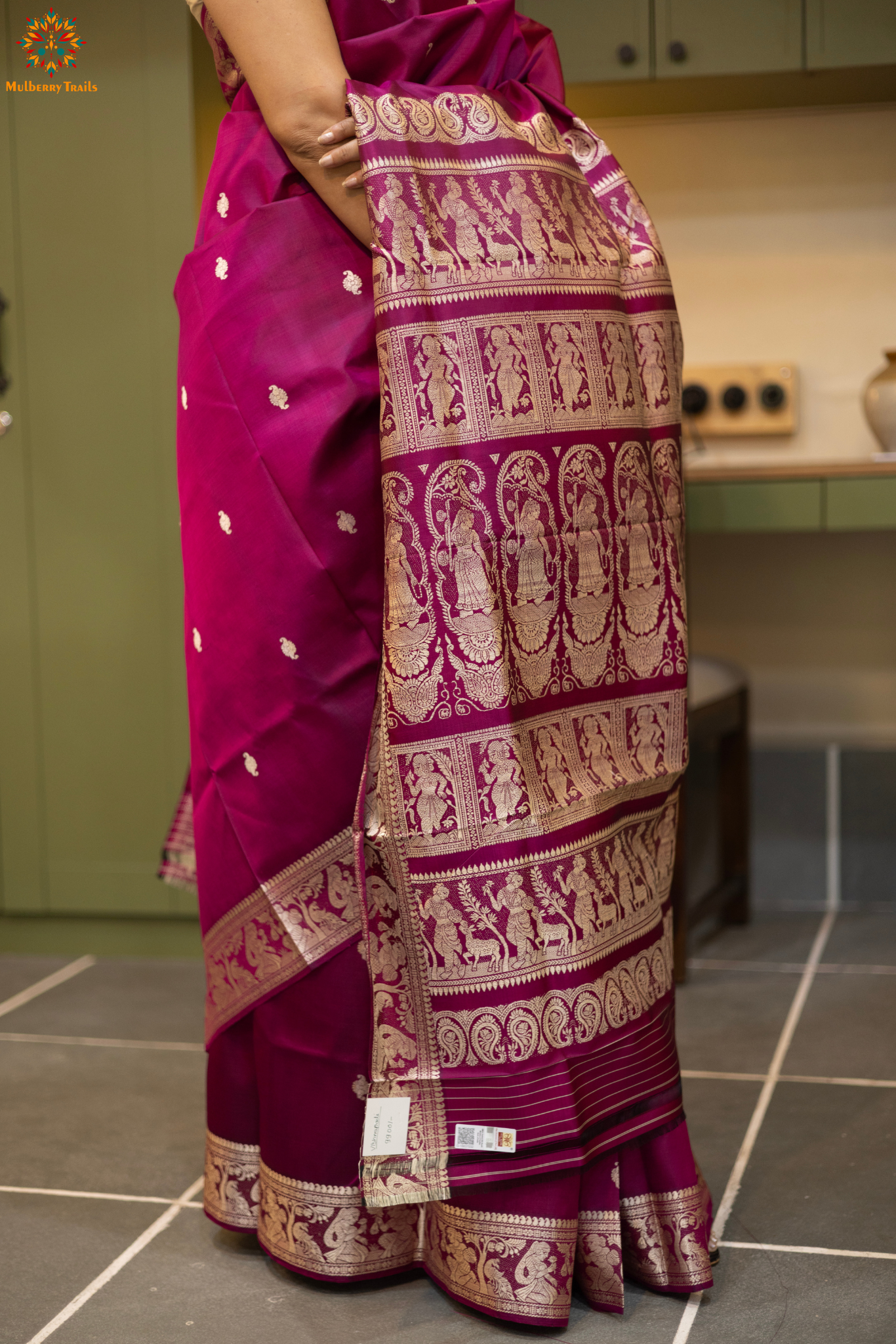 Woman wearing a traditional baluchari saree in a room with a desk and lamp. Woman in a carrot red and silver resham work saree standing indoors with a desk and lamp in the background.

Baluchari – Pure Silk Baluchari Saree

1. “Pure silk Baluchari saree with temple motif weave and Silver resham detailing for a regal look.”

2. “Silk Mark pure silk saree featuring intricate gold resham work motifs and rich texture. 