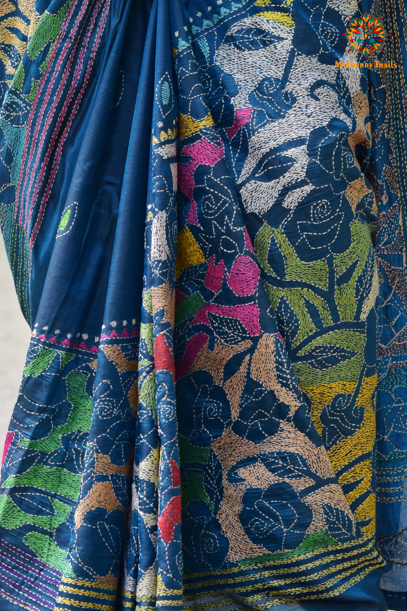 Art Silk saree with intricate Kantha embroidery featuring delicate floral and geometric patterns. The saree has a smooth, lightweight texture with vibrant threads that highlight the traditional hand-embroidery, adding a touch of elegance and cultural charm. Ideal for festive occasions, celebrations, or as a statement piece for special events.