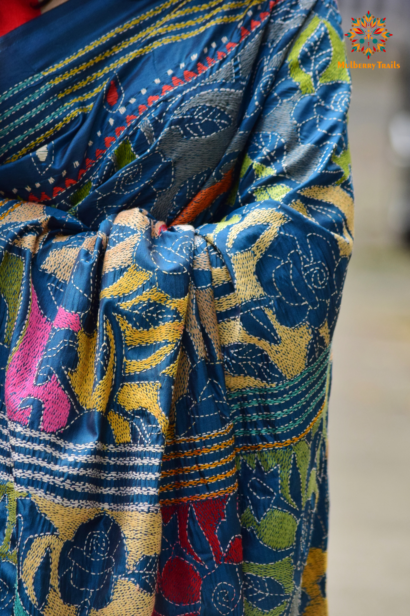 Art Silk saree with intricate Kantha embroidery featuring delicate floral and geometric patterns. The saree has a smooth, lightweight texture with vibrant threads that highlight the traditional hand-embroidery, adding a touch of elegance and cultural charm. Ideal for festive occasions, celebrations, or as a statement piece for special events.