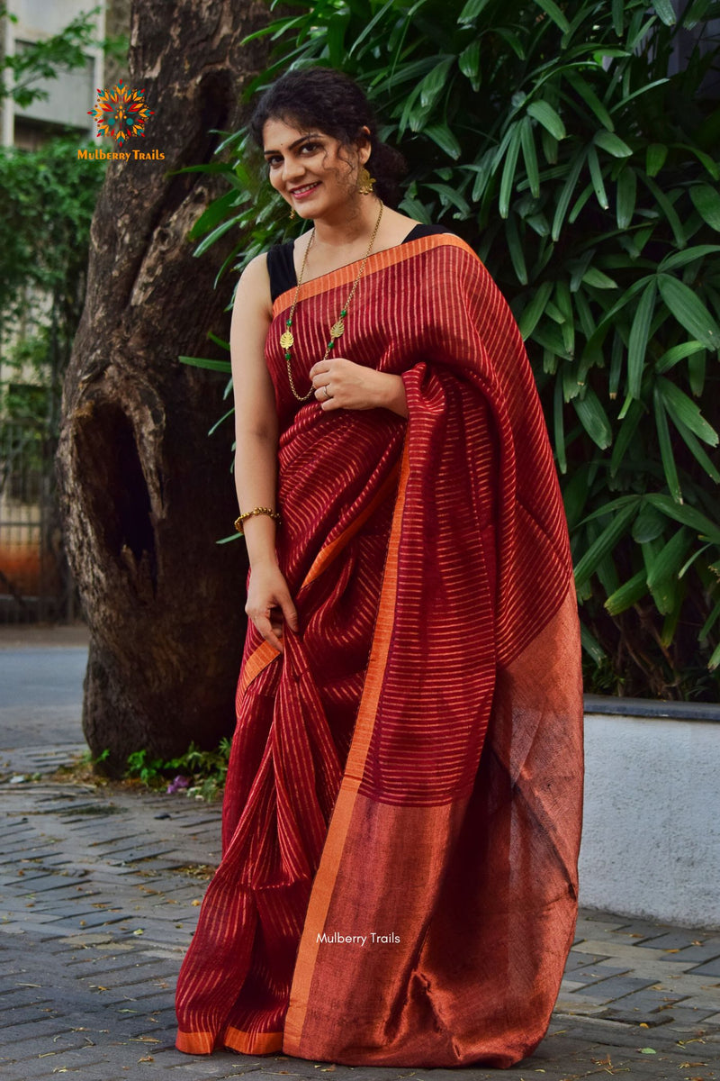 Premium saree for festivals, sophisticated saree, Luxury contemporary sari linen saree, handloom, stripes, tissue, unique copper zari work border, Model wearing Linen sari, Saree and blouse combination, saree for friends wedding, saree for wedding gift, saree for festive wear, sari for ganpati occassion, saree for diwali, luxurious handwoven linen sarees with modern copper zari 