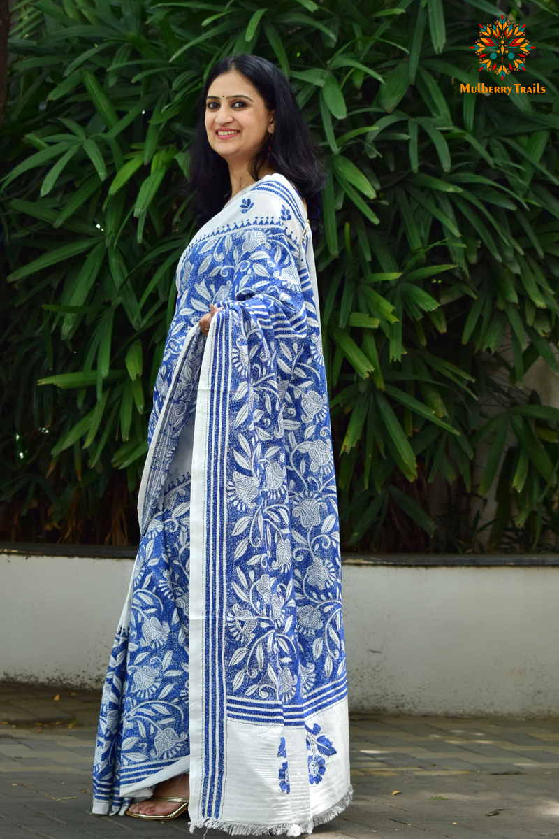 Art Silk saree with intricate Kantha embroidery featuring delicate floral and geometric patterns. The saree has a smooth, lightweight texture with vibrant threads that highlight the traditional hand-embroidery, adding a touch of elegance and cultural charm. Ideal for festive occasions, celebrations, or as a statement piece for special events.