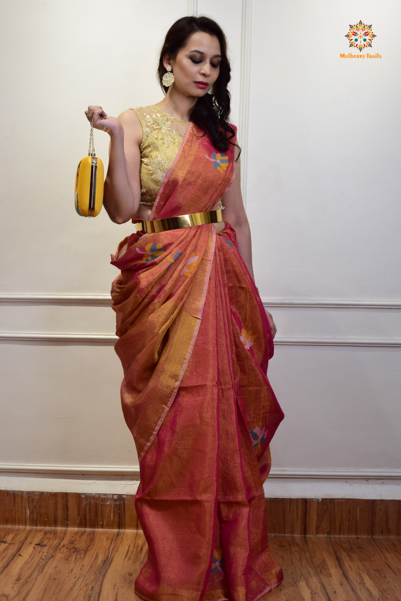 This image features an Elegant tissue saree featuring intricate handwoven Jamdani lotus motifs, with a lightweight, shimmery fabric that drapes beautifully, perfect for festive and special occasions. Party wear , diwali theme. 