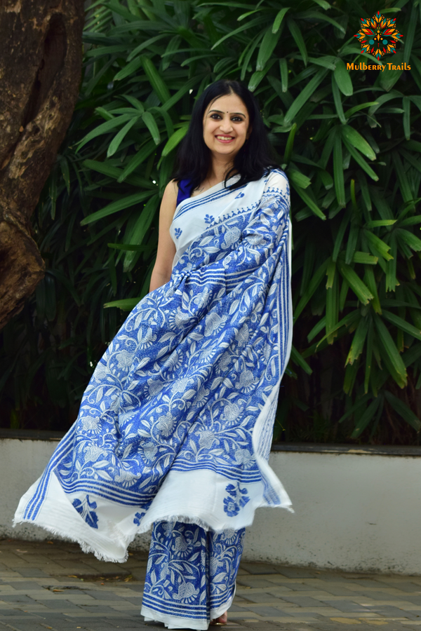 Art Silk saree with intricate Kantha embroidery featuring delicate floral and geometric patterns. The saree has a smooth, lightweight texture with vibrant threads that highlight the traditional hand-embroidery, adding a touch of elegance and cultural charm. Ideal for festive occasions, celebrations, or as a statement piece for special events.