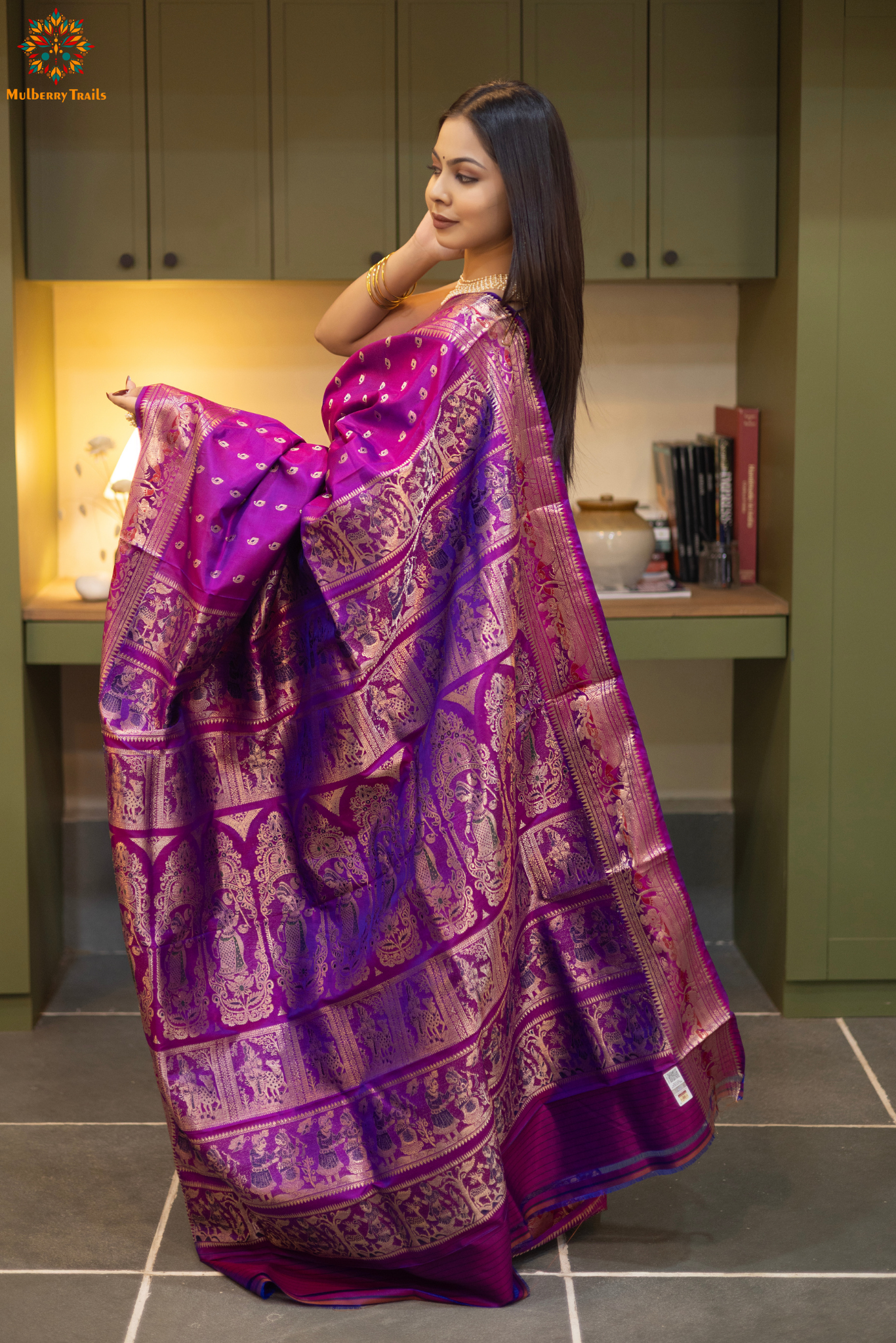 Woman wearing a purple saree with a pattern in a room. Woman in a pink saree standing in a elegant setting. 
Swarnachari – Pure Silk Hazarbutta Saree

1. “Pure silk Swarnachari saree with hazarbutta thousand-motif weave and copper zari detailing for a regal look.”

2. “Silk Mark pure silk hazarbutta saree featuring intricate copper zari motifs and rich texture.” 
Woman wearing a black and copper zari saree in a room with a desk and lamp.