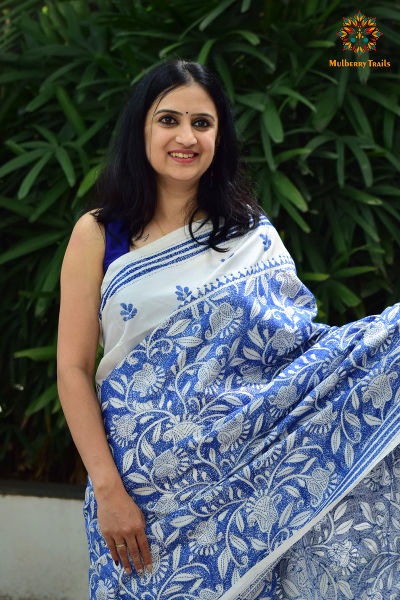 Art Silk saree with intricate Kantha embroidery featuring delicate floral and geometric patterns. The saree has a smooth, lightweight texture with vibrant threads that highlight the traditional hand-embroidery, adding a touch of elegance and cultural charm. Ideal for festive occasions, celebrations, or as a statement piece for special events.