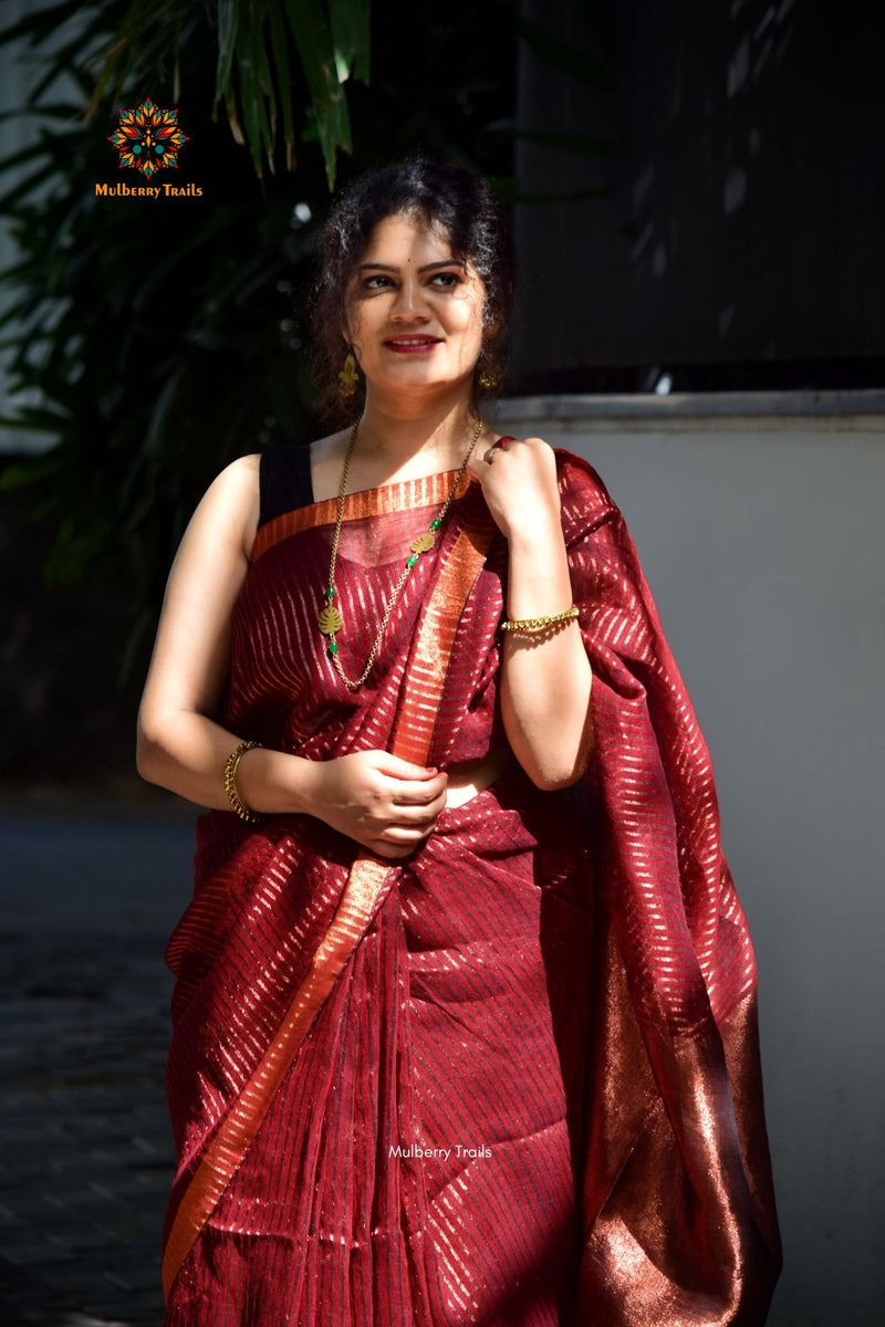 Premium saree for festivals, sophisticated saree, Luxury contemporary sari linen saree, handloom, stripes, tissue, unique copper zari work border, Model wearing Linen sari, Saree and blouse combination, saree for friends wedding, saree for wedding gift, saree for festive wear, sari for ganpati occassion, saree for diwali, luxurious handwoven linen sarees with modern copper zari 