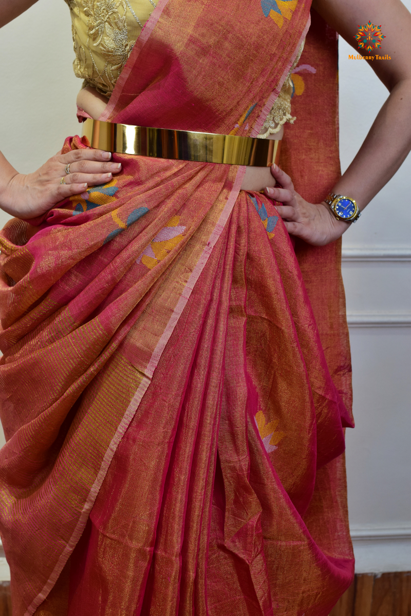 This image features an Elegant tissue saree featuring intricate handwoven Jamdani lotus motifs, with a lightweight, shimmery fabric that drapes beautifully, perfect for festive and special occasions. Party wear , diwali theme. 