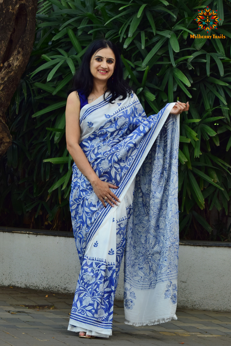 Art Silk saree with intricate Kantha embroidery featuring delicate floral and geometric patterns. The saree has a smooth, lightweight texture with vibrant threads that highlight the traditional hand-embroidery, adding a touch of elegance and cultural charm. Ideal for festive occasions, celebrations, or as a statement piece for special events.