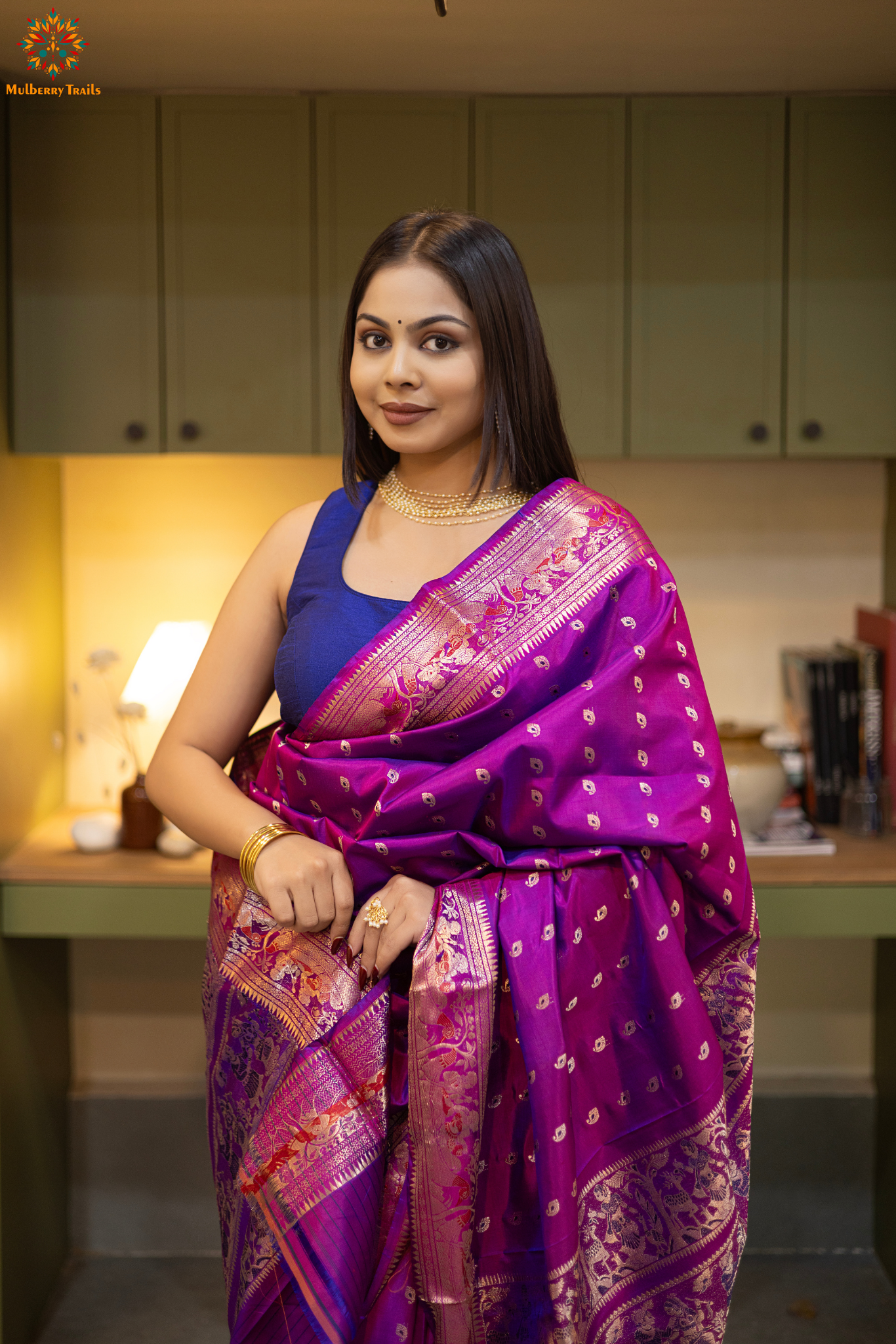 Woman wearing a purple saree with a pattern in a room. Woman in a pink saree standing in a elegant setting. 
Swarnachari – Pure Silk Hazarbutta Saree

1. “Pure silk Swarnachari saree with hazarbutta thousand-motif weave and copper zari detailing for a regal look.”

2. “Silk Mark pure silk hazarbutta saree featuring intricate copper zari motifs and rich texture.” 
Woman wearing a black and copper zari saree in a room with a desk and lamp.