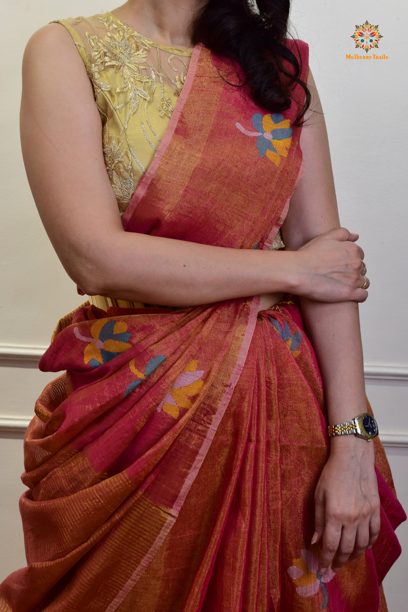 This image features an Elegant tissue saree featuring intricate handwoven Jamdani lotus motifs, with a lightweight, shimmery fabric that drapes beautifully, perfect for festive and special occasions. Party wear , diwali theme. 