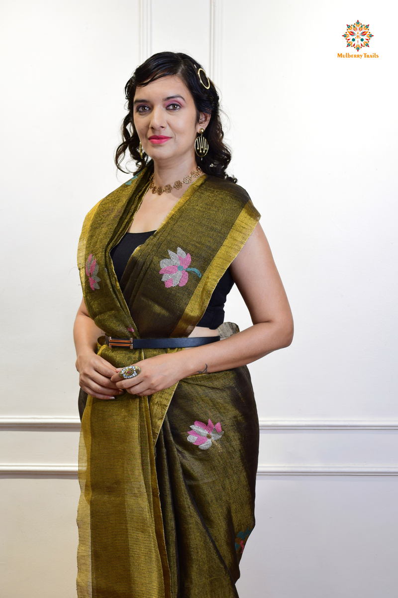 This image features an Elegant tissue saree featuring intricate handwoven Jamdani lotus motifs, with a lightweight, shimmery fabric that drapes beautifully, perfect for festive and special occasions. Party wear , diwali theme. 