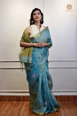 This image features an Elegant tissue saree featuring intricate handwoven Jamdani lotus motifs, with a lightweight, shimmery fabric that drapes beautifully, perfect for festive and special occasions. Party wear , diwali theme. 