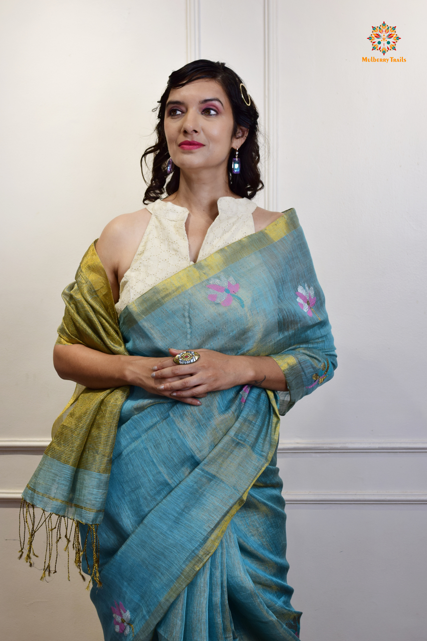 This image features an Elegant tissue saree featuring intricate handwoven Jamdani lotus motifs, with a lightweight, shimmery fabric that drapes beautifully, perfect for festive and special occasions. Party wear , diwali theme. 