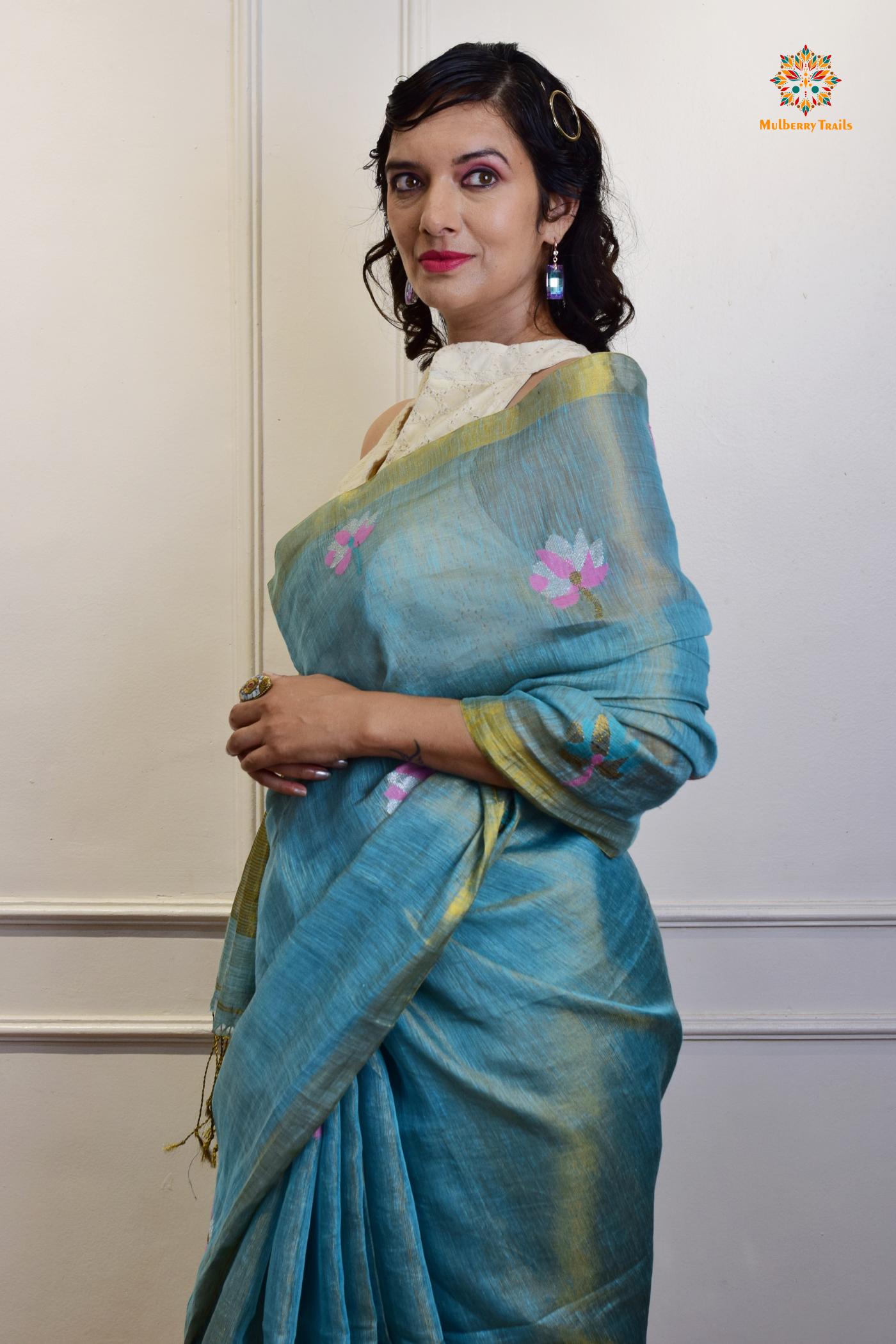 This image features an Elegant tissue saree featuring intricate handwoven Jamdani lotus motifs, with a lightweight, shimmery fabric that drapes beautifully, perfect for festive and special occasions. Party wear , diwali theme. 