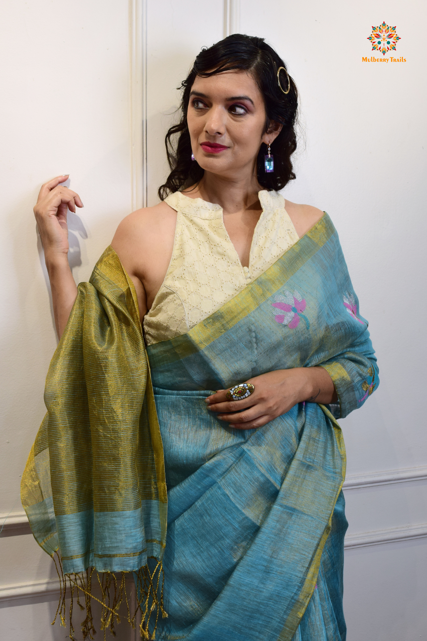 This image features an Elegant tissue saree featuring intricate handwoven Jamdani lotus motifs, with a lightweight, shimmery fabric that drapes beautifully, perfect for festive and special occasions. Party wear , diwali theme. 