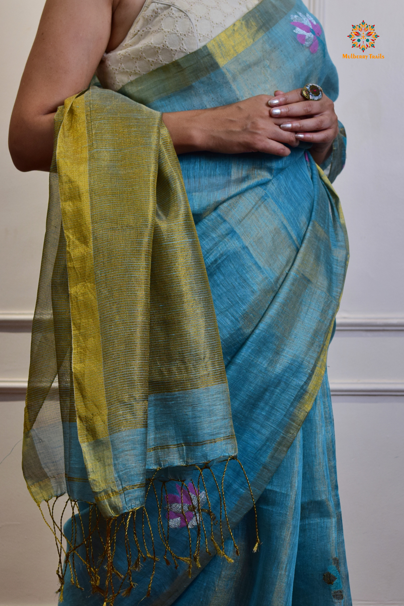 This image features an Elegant tissue saree featuring intricate handwoven Jamdani lotus motifs, with a lightweight, shimmery fabric that drapes beautifully, perfect for festive and special occasions. Party wear , diwali theme. 