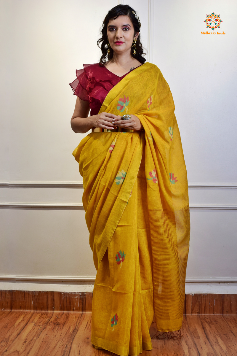 This image features an Elegant tissue saree featuring intricate handwoven Jamdani lotus motifs, with a lightweight, shimmery fabric that drapes beautifully, perfect for festive and special occasions. Party wear , diwali theme. 