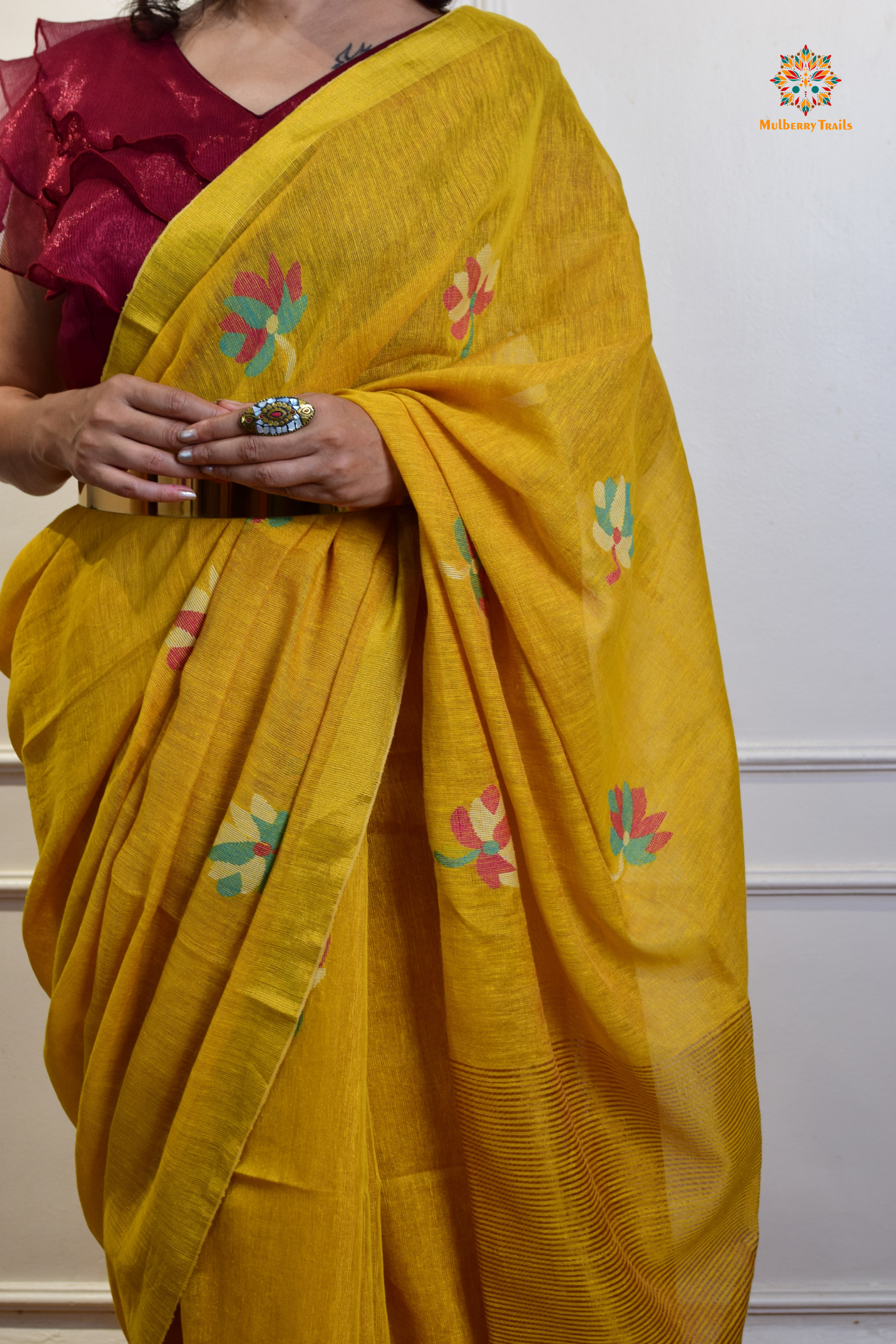 This image features an Elegant tissue saree featuring intricate handwoven Jamdani lotus motifs, with a lightweight, shimmery fabric that drapes beautifully, perfect for festive and special occasions. Party wear , diwali theme. 