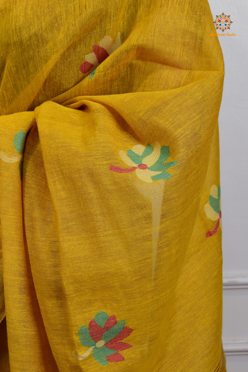 This image features an Elegant tissue saree featuring intricate handwoven Jamdani lotus motifs, with a lightweight, shimmery fabric that drapes beautifully, perfect for festive and special occasions. Party wear , diwali theme. 