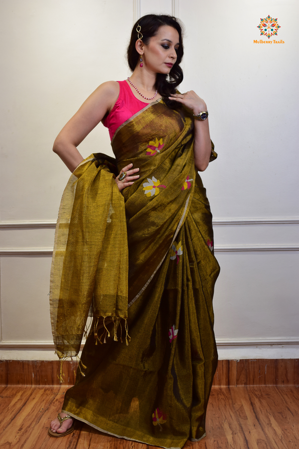 This image features an Elegant tissue saree featuring intricate handwoven Jamdani lotus motifs, with a lightweight, shimmery fabric that drapes beautifully, perfect for festive and special occasions. Party wear , diwali theme. 