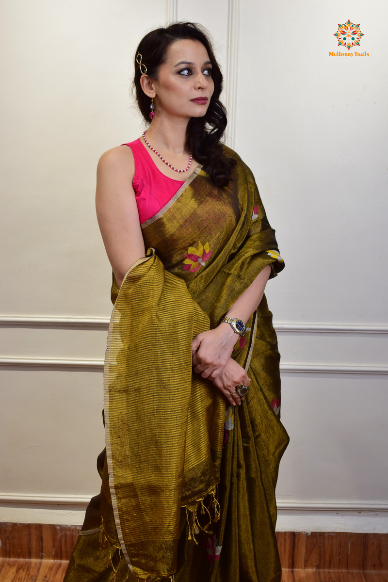 This image features an Elegant tissue saree featuring intricate handwoven Jamdani lotus motifs, with a lightweight, shimmery fabric that drapes beautifully, perfect for festive and special occasions. Party wear , diwali theme. 