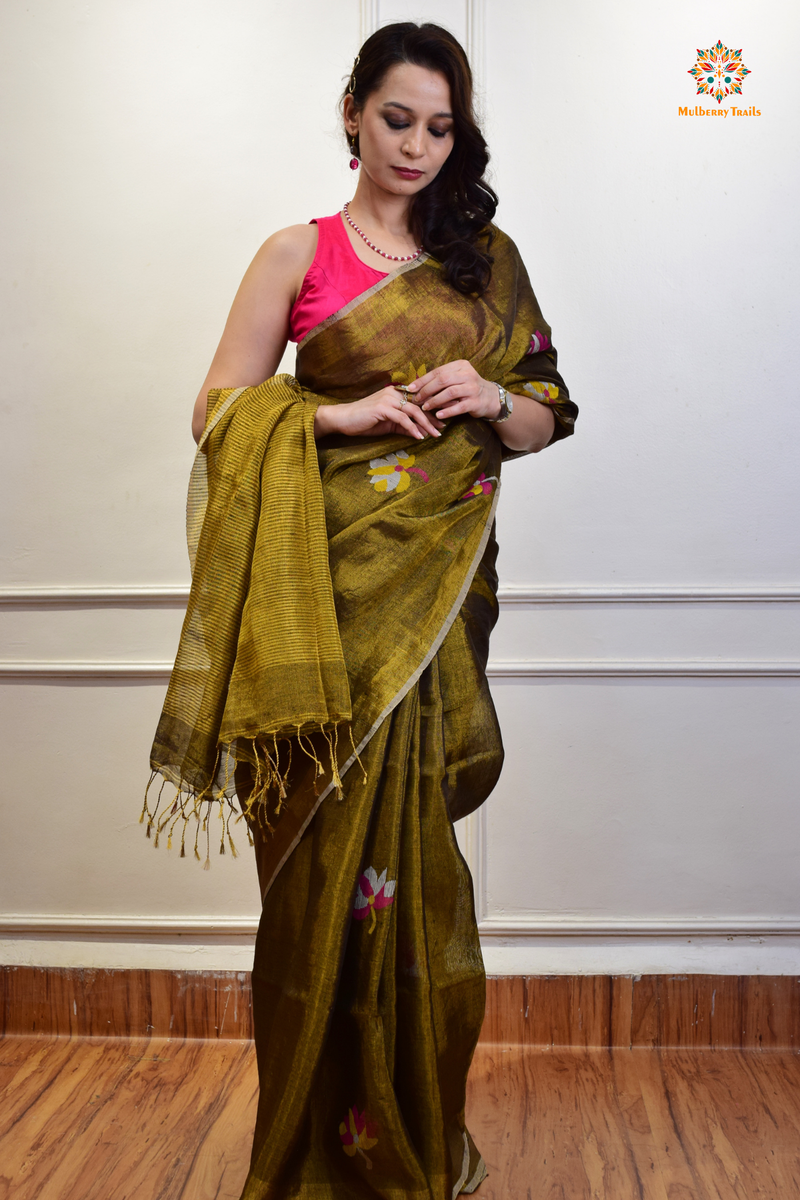 This image features an Elegant tissue saree featuring intricate handwoven Jamdani lotus motifs, with a lightweight, shimmery fabric that drapes beautifully, perfect for festive and special occasions. Party wear , diwali theme. 