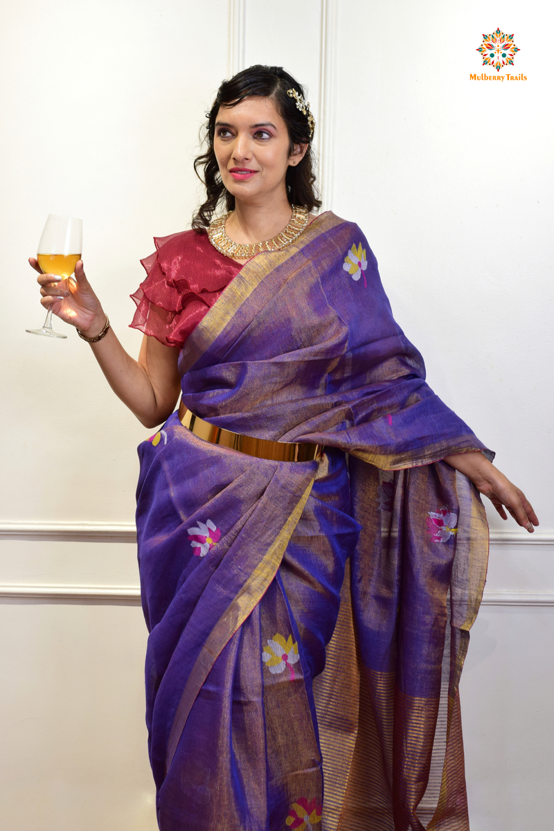 This image features an Elegant tissue saree featuring intricate handwoven Jamdani lotus motifs, with a lightweight, shimmery fabric that drapes beautifully, perfect for festive and special occasions. Party wear , diwali theme. 